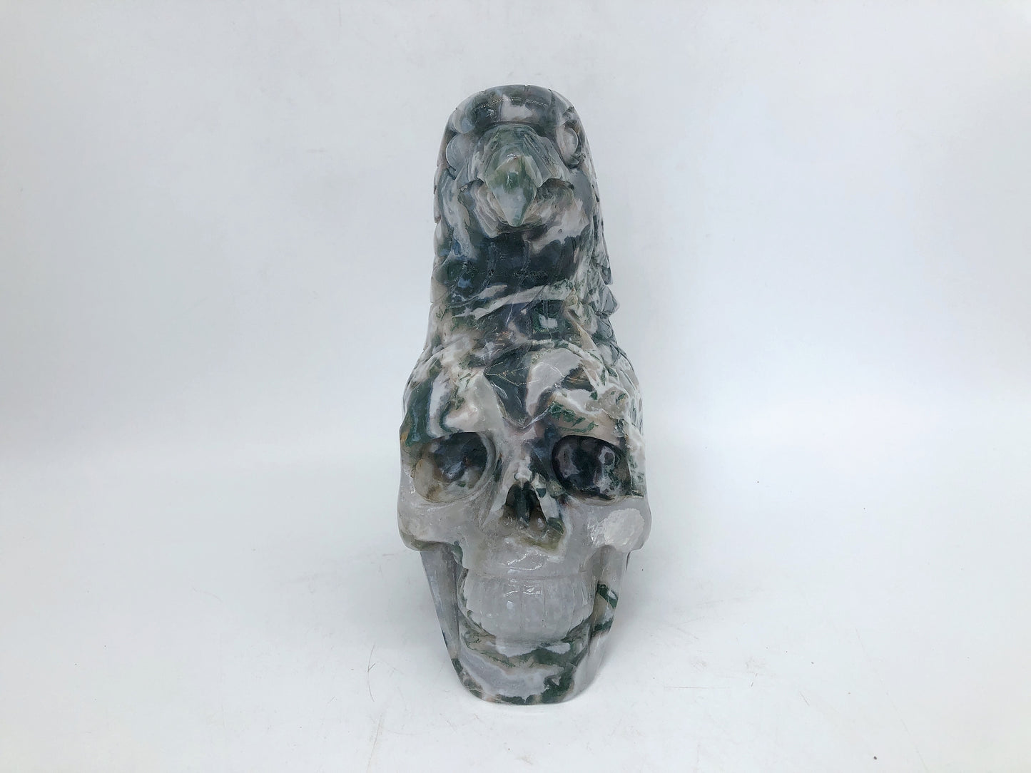 Moss agate skull with eagle carving