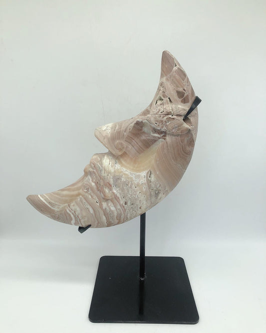Orange calcite moon face carving