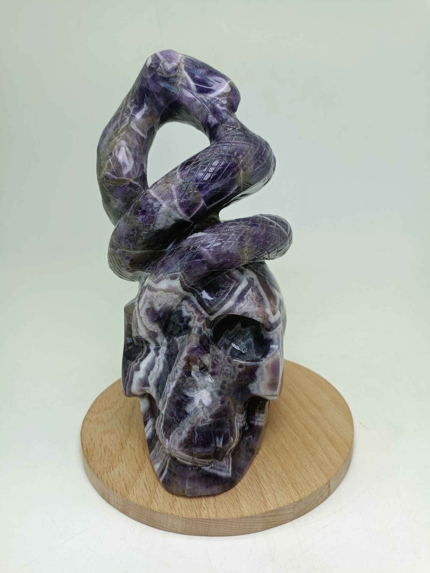 Amethyst skull with snake carving