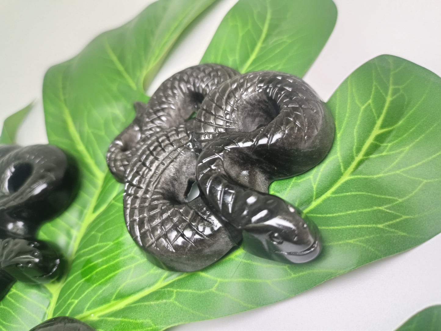 Silver obsidian snake carving