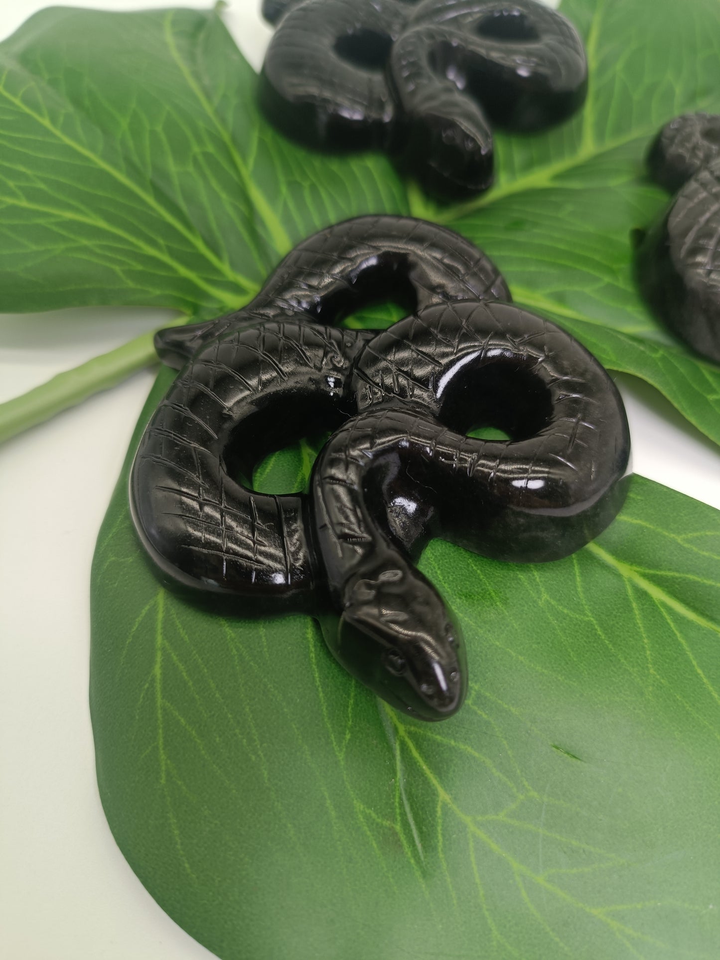 Silver obsidian snake carving