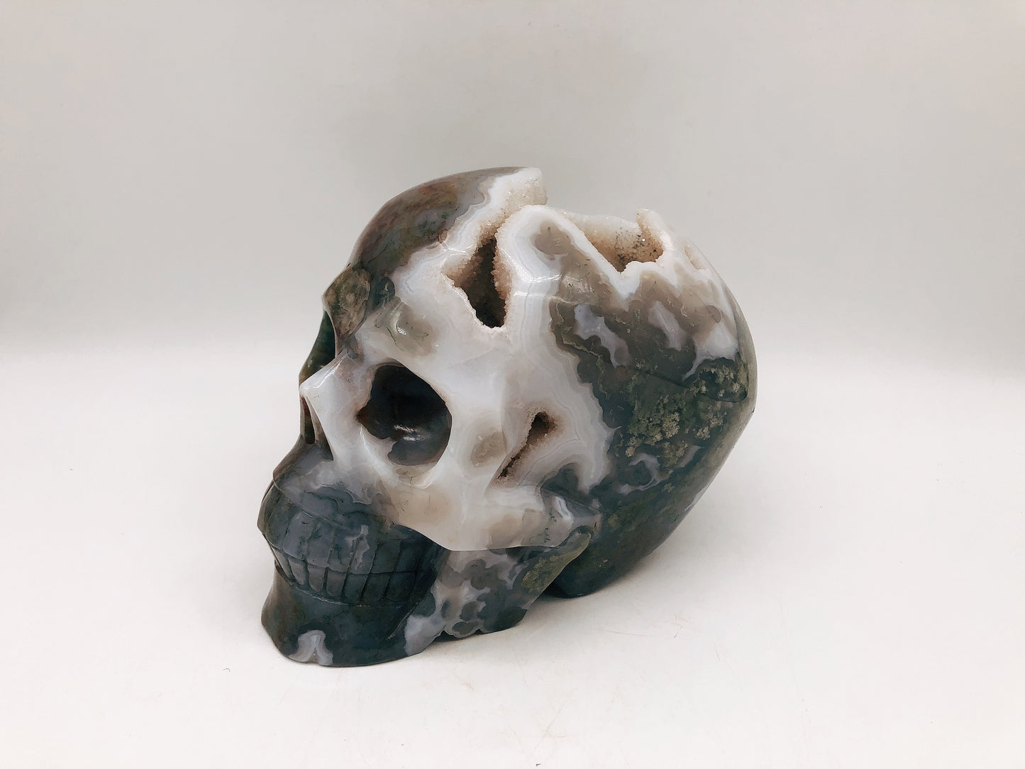 Moss agate skull carving