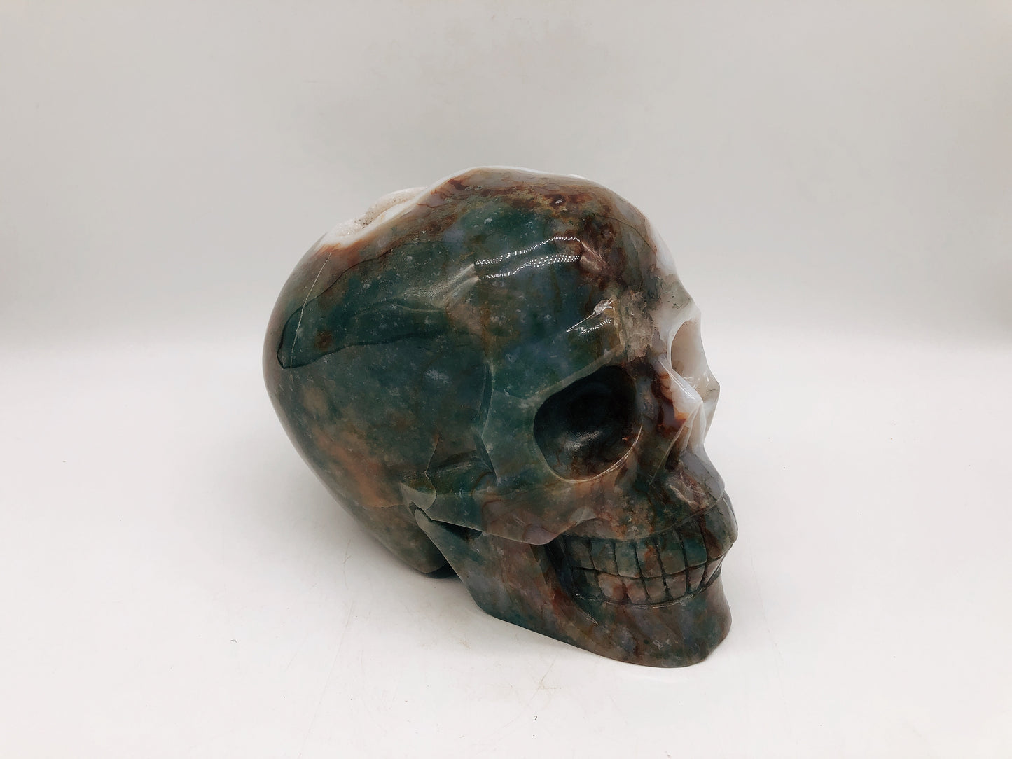 Moss agate skull carving