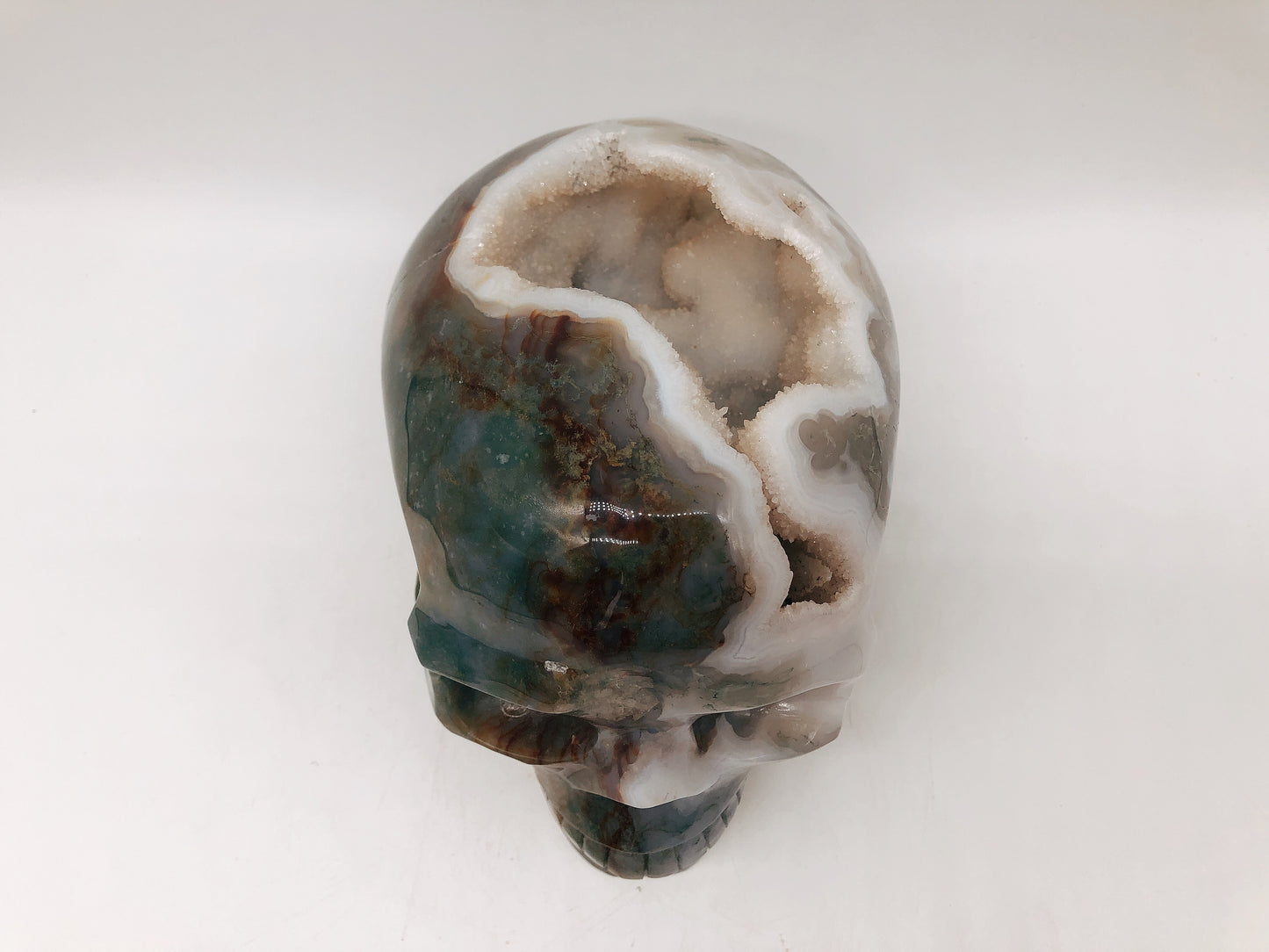 Moss agate skull carving