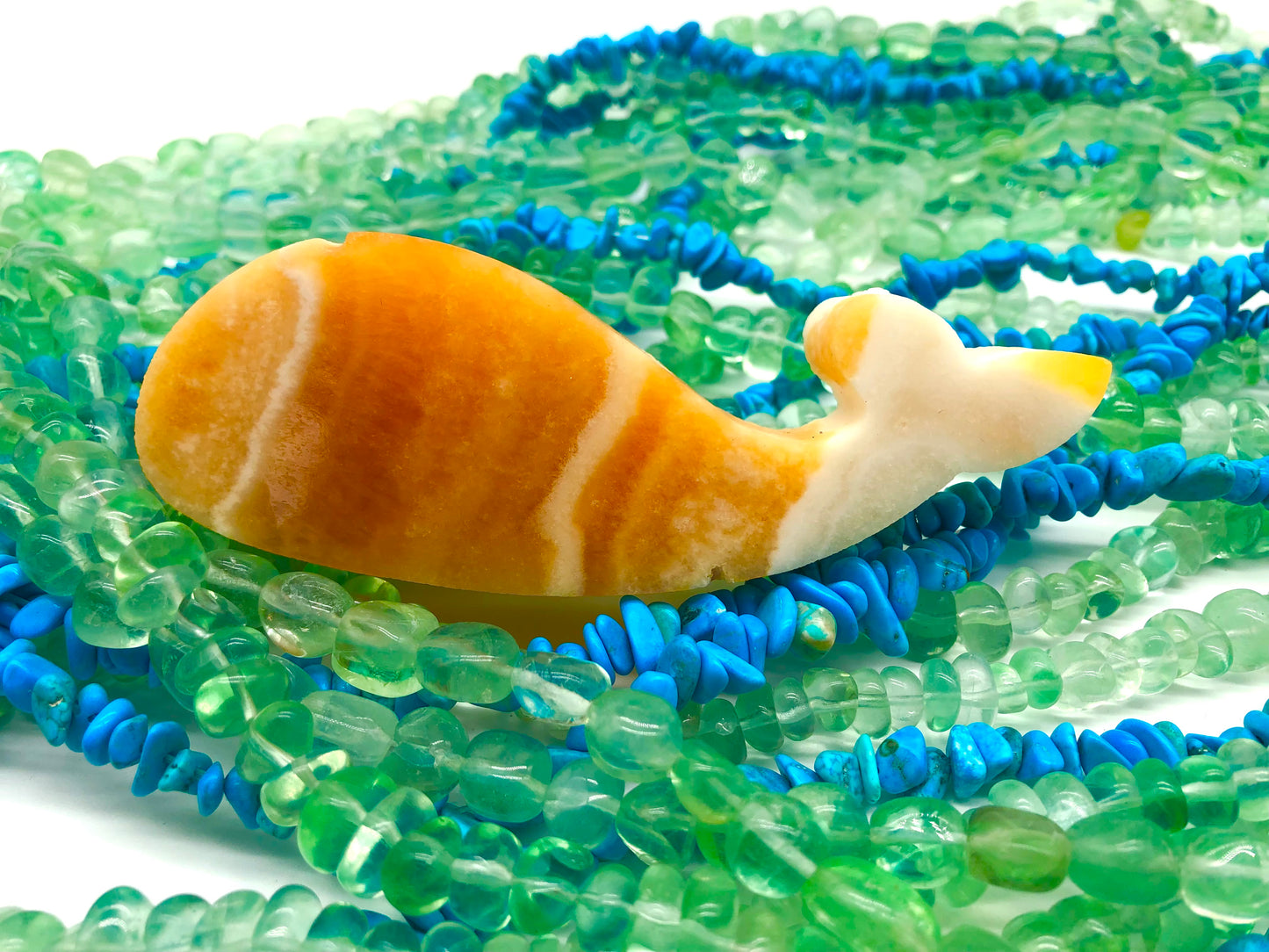Orange calcite whale carving