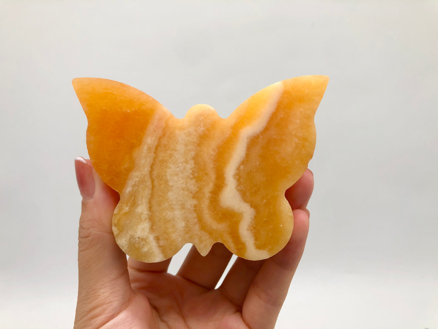 Orange calcite butterfly carving