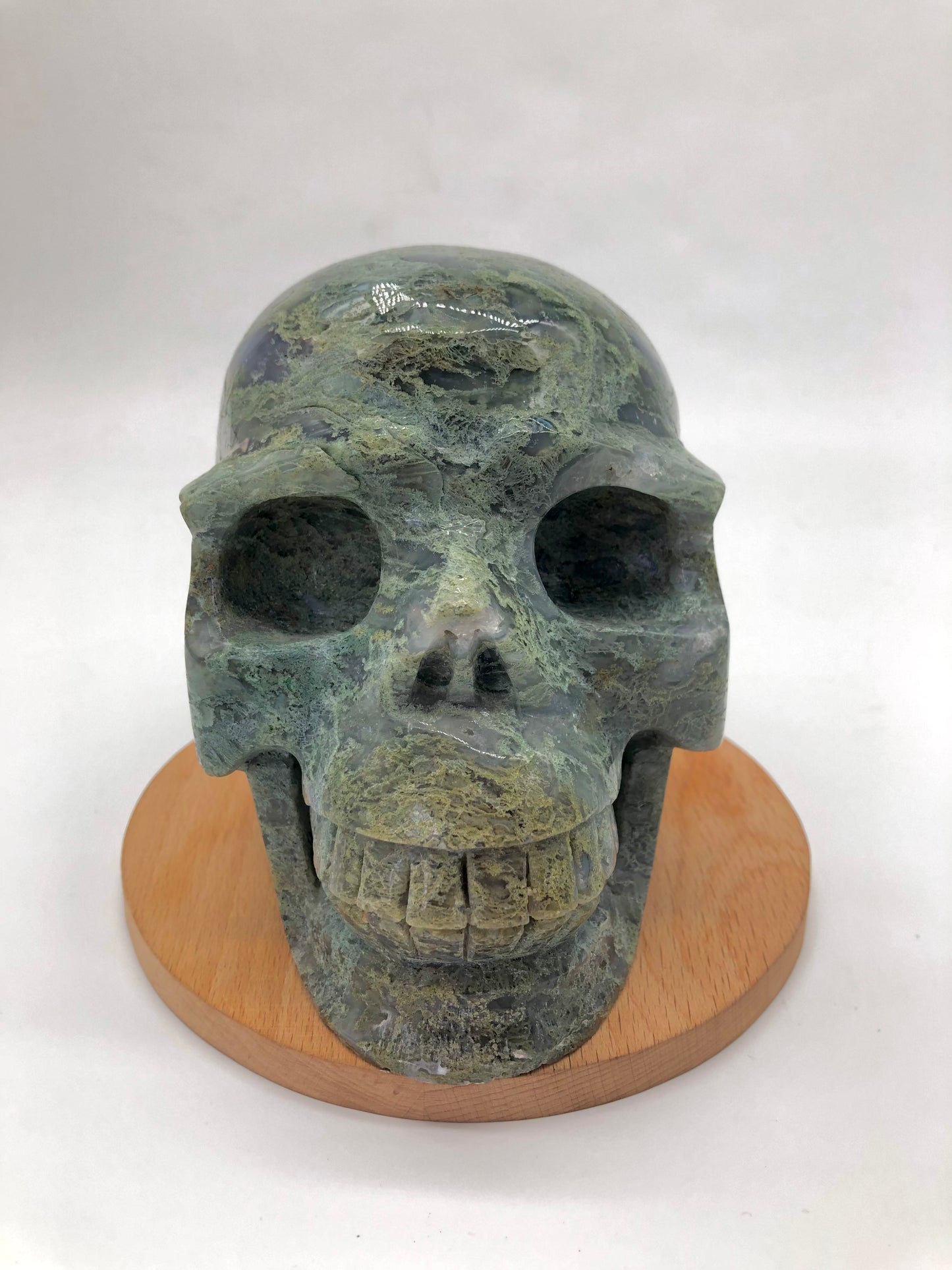 Moss agate skull carving