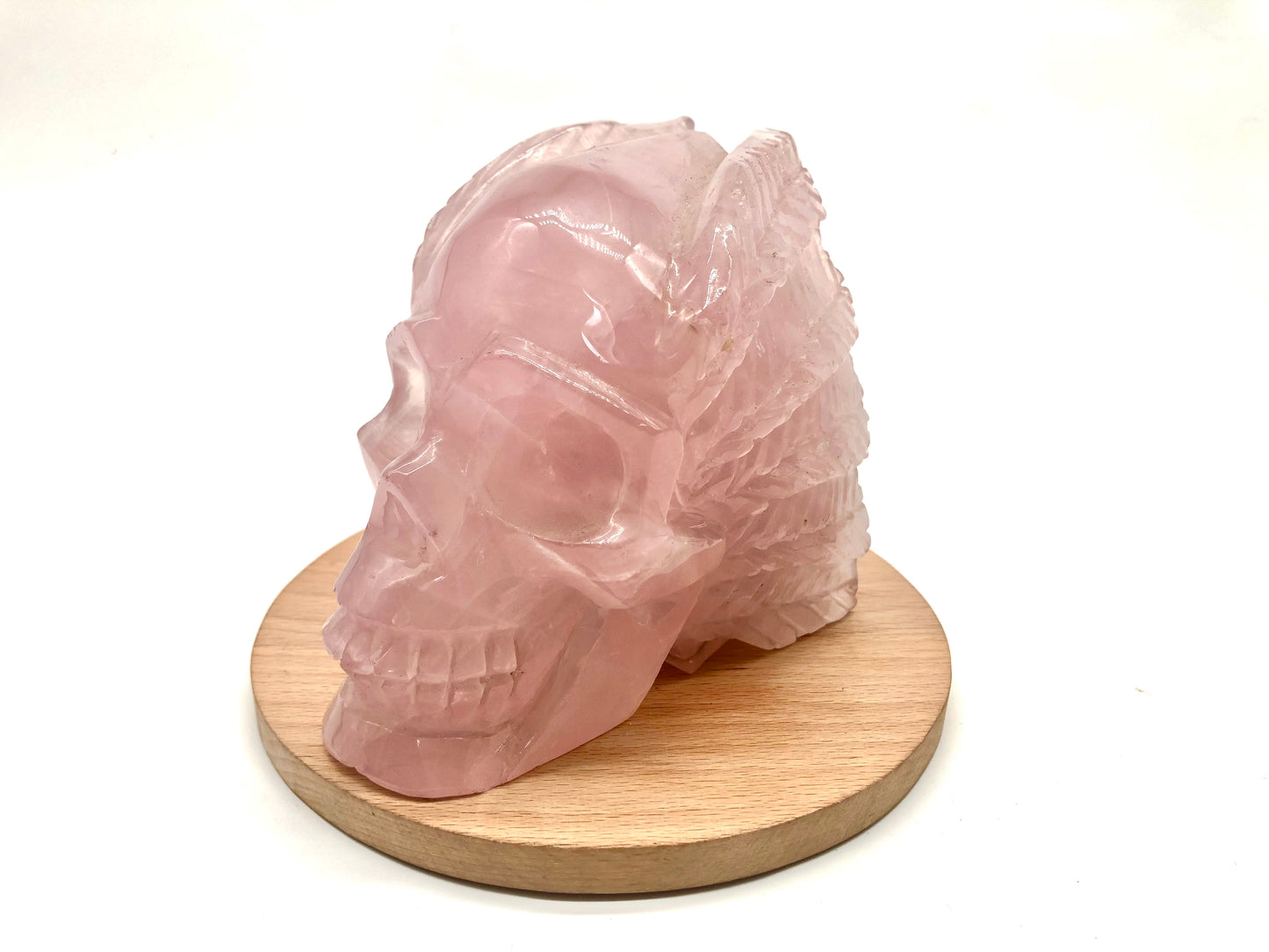 Rose quartz skull with leaves carving