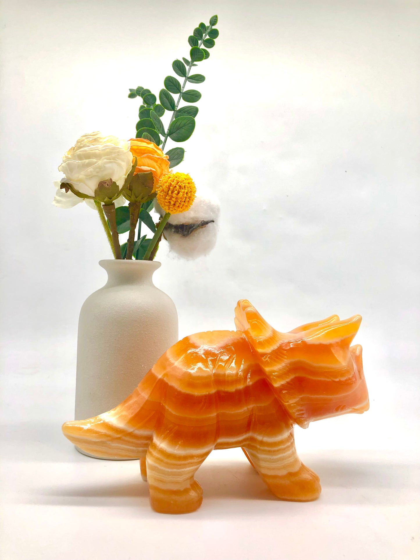 Orange calcite dinosaur carving