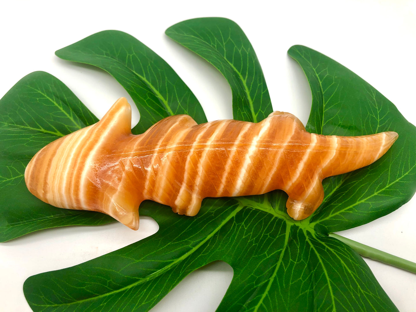 Orange calcite lizard carving